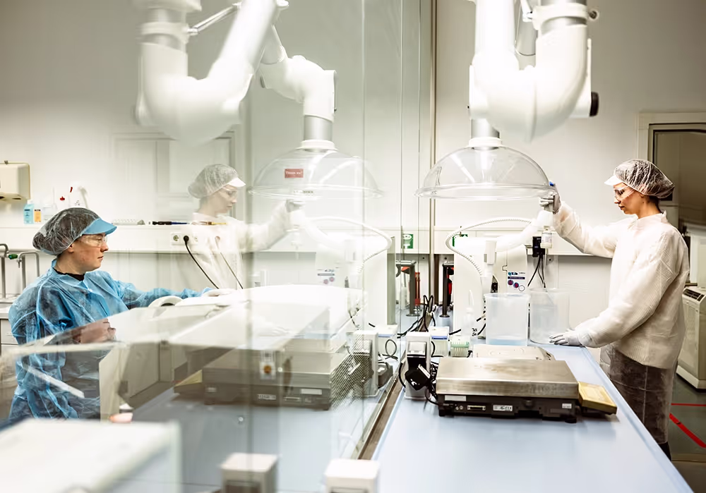 Lab employees producing buffer