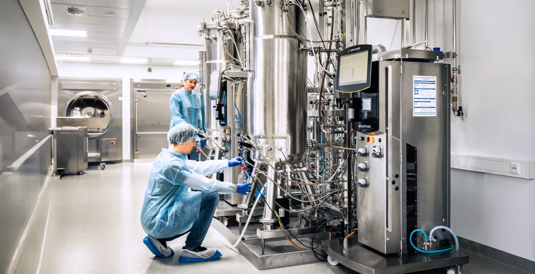 Lab employees operating 200L bioreactors